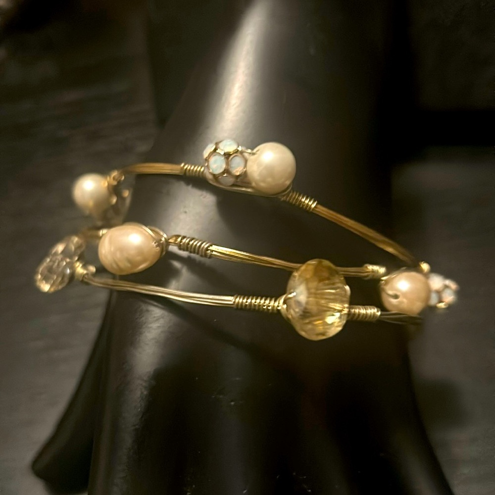 Three gold tone, wire, wrapped bracelets with crystals, organic pearls & beads.